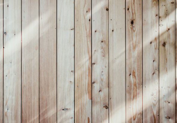 a close up of a wooden wall with a light shining on it
